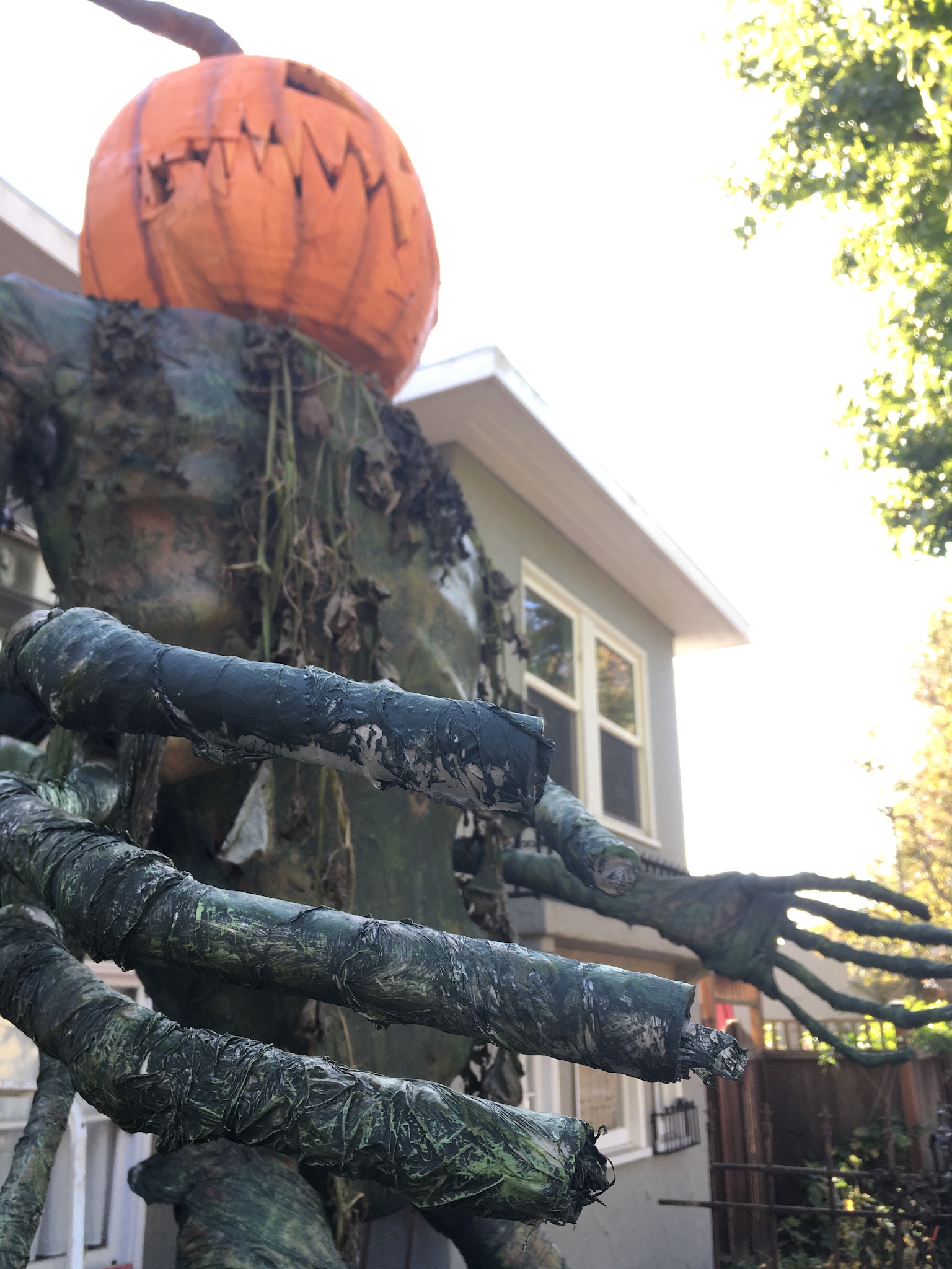 Closeup of Pumpkin Man's textured green fingers