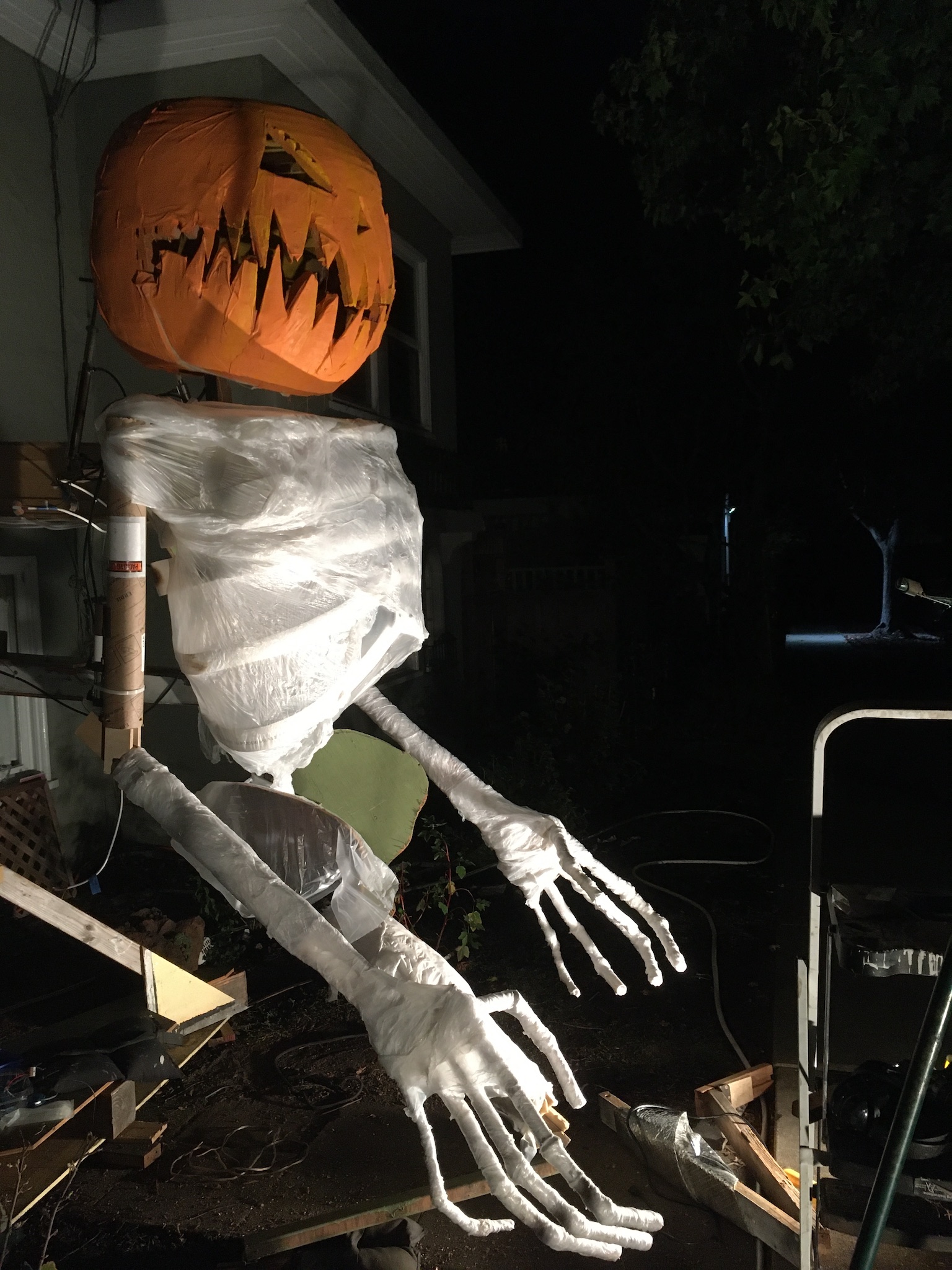Pumpkin Man with his ribs, arms, and hands covered in plastic